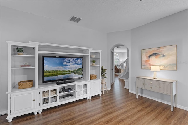 living room with hardwood / wood-style floors and a textured ceiling