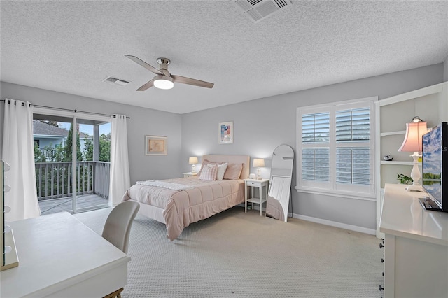 carpeted bedroom with access to exterior, a textured ceiling, and ceiling fan