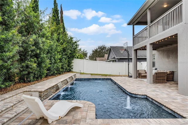 view of pool with pool water feature, a patio area, and an outdoor hangout area