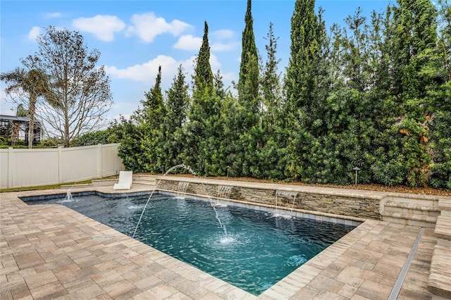 view of pool with pool water feature and a patio