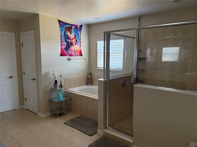 bathroom featuring a textured ceiling, shower with separate bathtub, and tile patterned floors