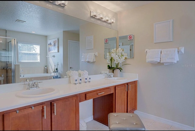 bathroom with vanity, tile patterned flooring, plus walk in shower, and a textured ceiling