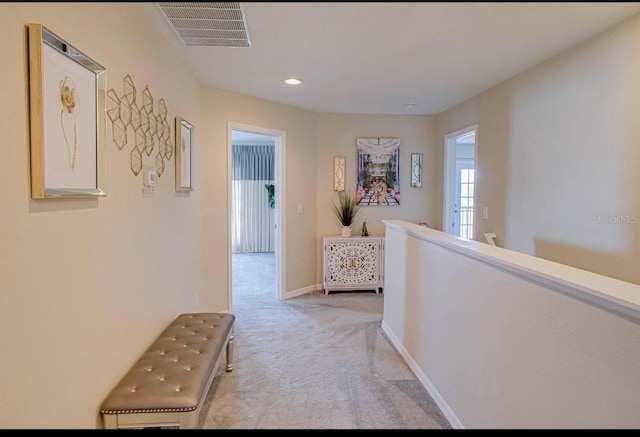 hallway featuring light carpet