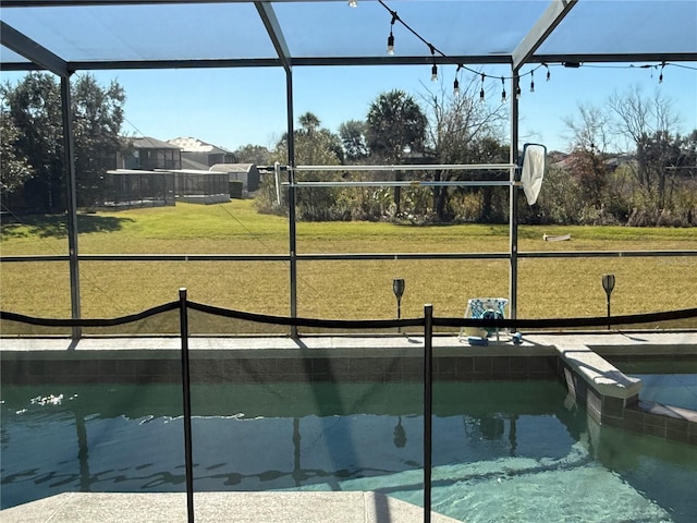 view of swimming pool featuring glass enclosure and a yard