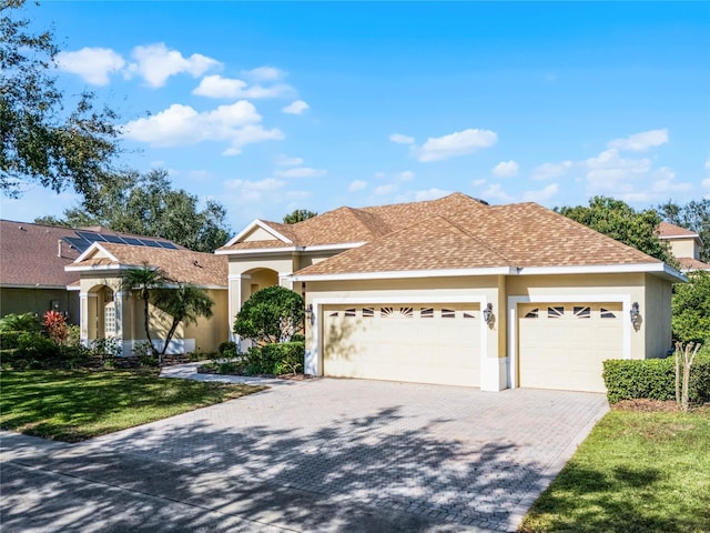 view of front of property with a front lawn and a garage