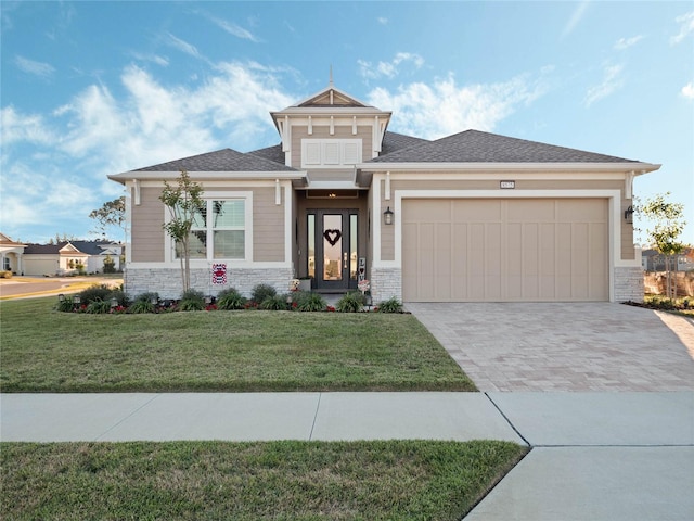 prairie-style home with a garage and a front lawn