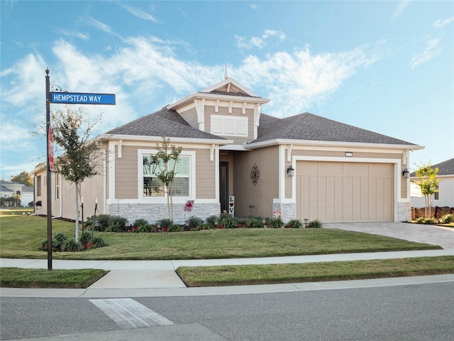 view of front of house with a garage and a front yard