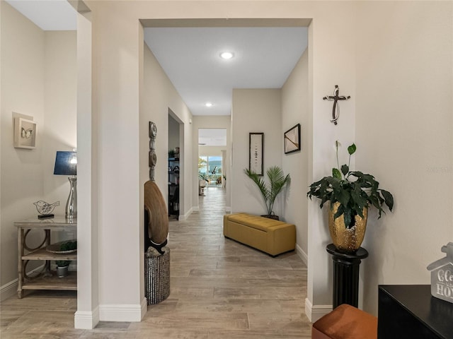 hallway with light hardwood / wood-style flooring