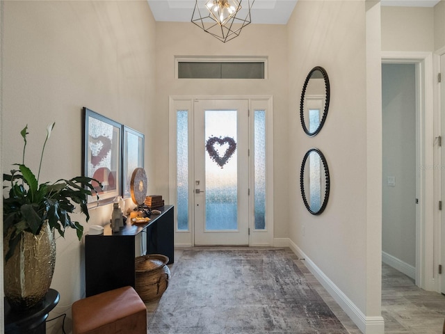 foyer with an inviting chandelier and a high ceiling