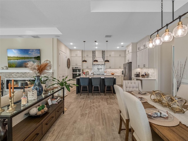 dining space with light hardwood / wood-style floors