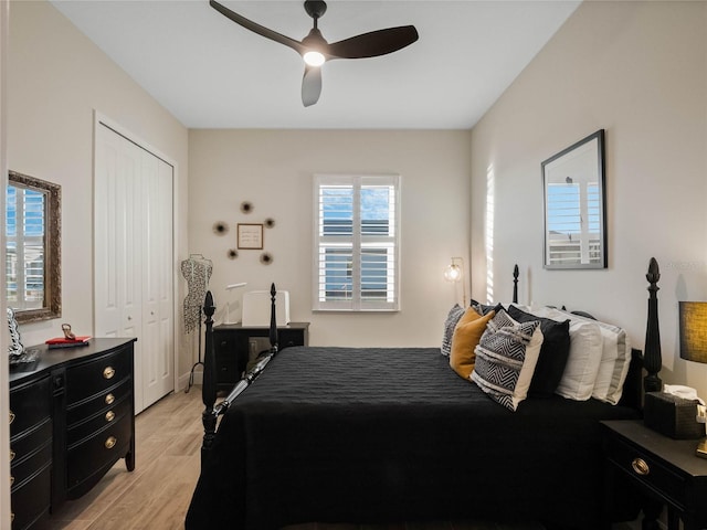 bedroom with ceiling fan, a closet, and light wood-type flooring