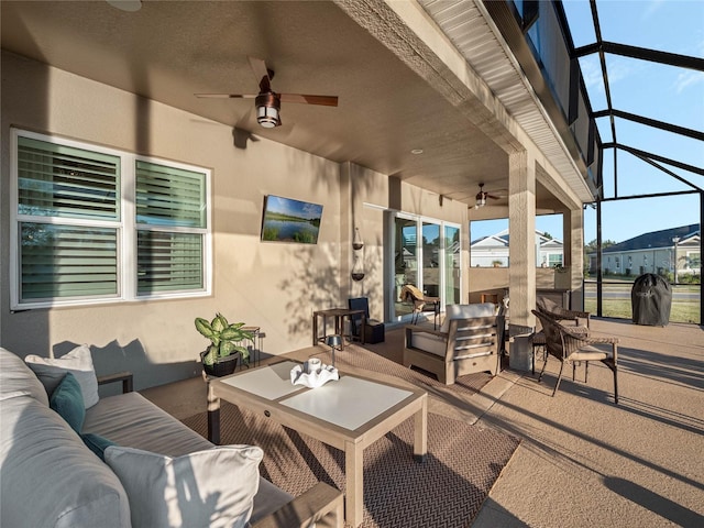 view of patio featuring ceiling fan, outdoor lounge area, and a lanai