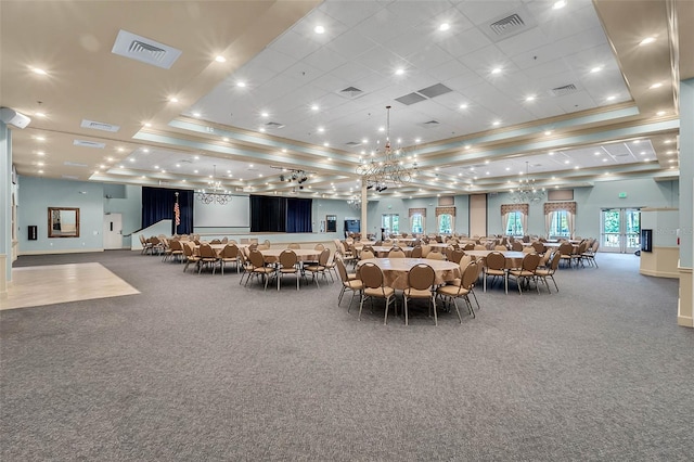 carpeted dining space with ornamental molding and a tray ceiling