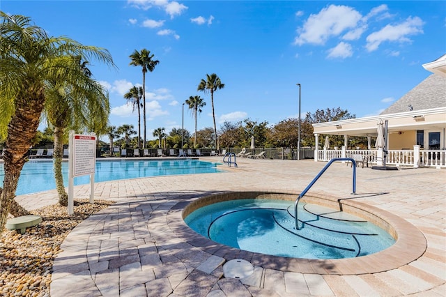 view of swimming pool with a community hot tub and a patio