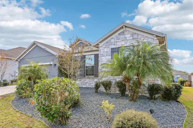 view of front of property with stone siding and an attached garage