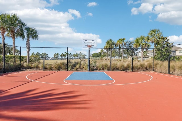 view of basketball court with community basketball court and fence