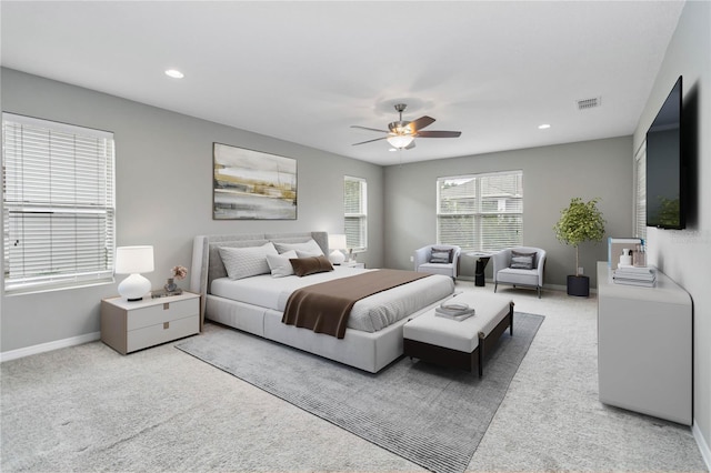 carpeted bedroom featuring ceiling fan, recessed lighting, visible vents, and baseboards