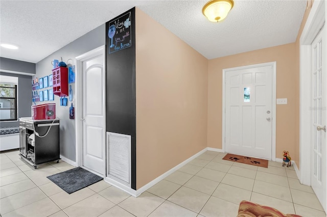 tiled foyer featuring a textured ceiling