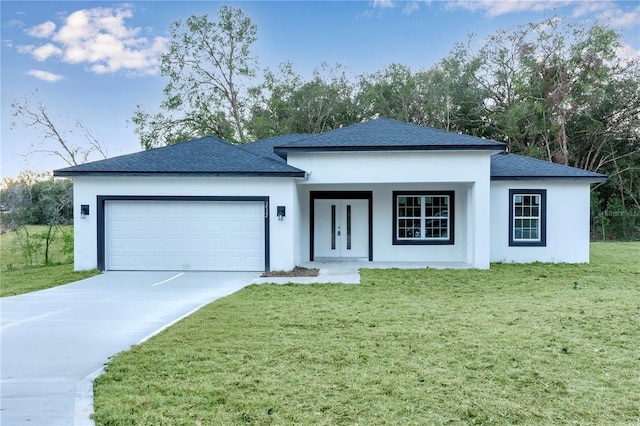 view of front of home with a garage and a front lawn