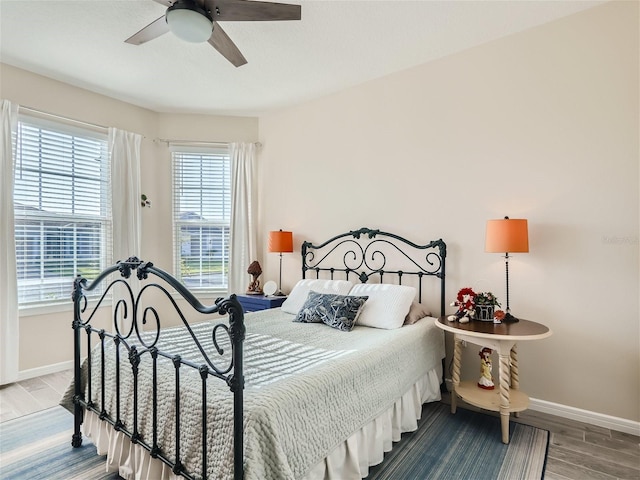 bedroom with light hardwood / wood-style flooring and ceiling fan