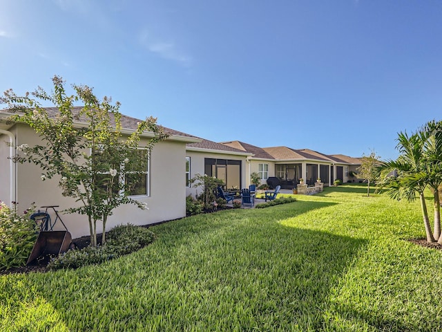 rear view of house with a yard and a patio area