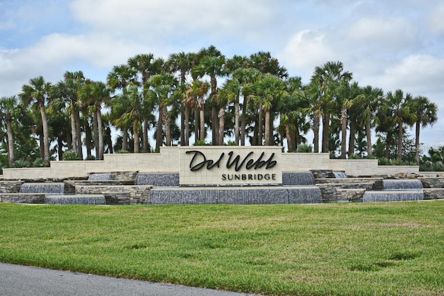 community sign featuring a lawn