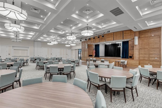 dining area featuring a high ceiling, coffered ceiling, light colored carpet, and beam ceiling