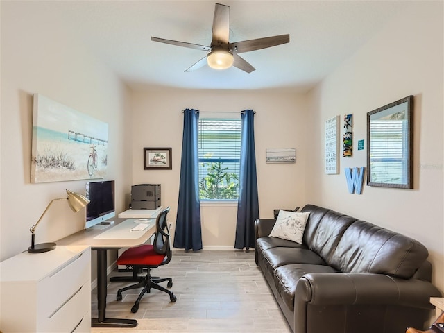 office area with light hardwood / wood-style flooring and ceiling fan