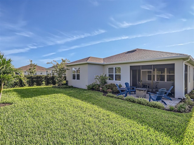 rear view of property featuring an outdoor fire pit, a patio area, and a lawn