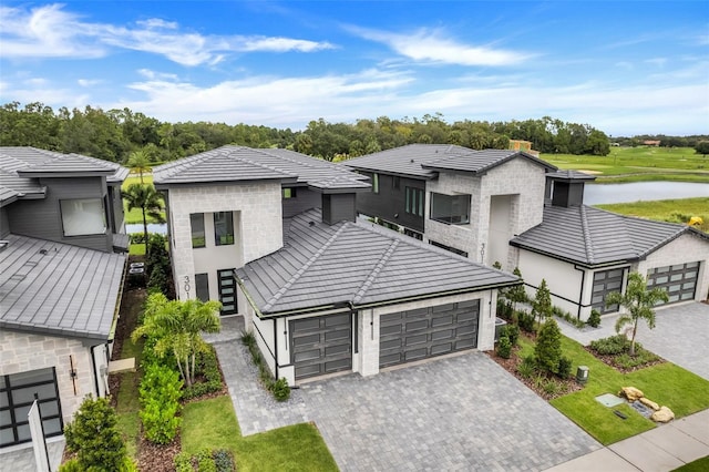 view of front facade with a garage and a water view