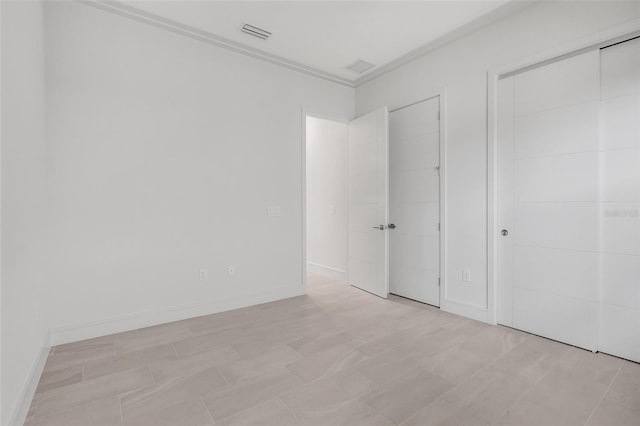 unfurnished bedroom with crown molding