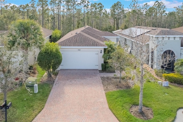 view of front of property with a garage and a front lawn