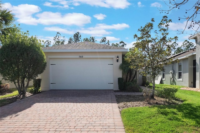 ranch-style house featuring a garage and a front lawn