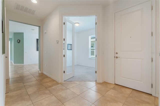 corridor with light tile patterned floors