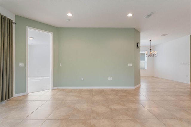 tiled empty room with a notable chandelier