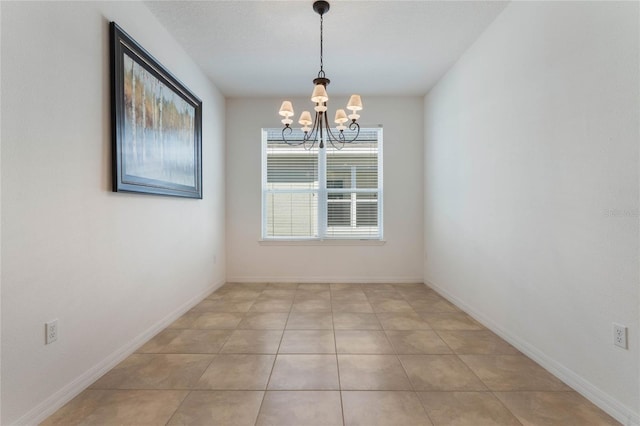 unfurnished dining area with light tile patterned floors and a notable chandelier