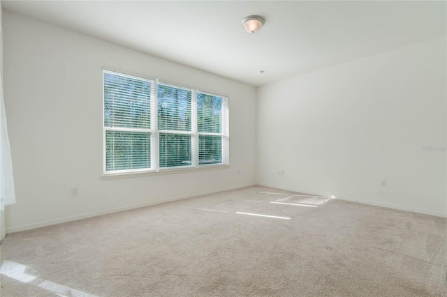 spare room with light colored carpet