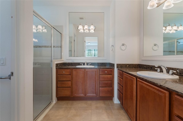 bathroom with tile patterned flooring, vanity, and a shower with shower door