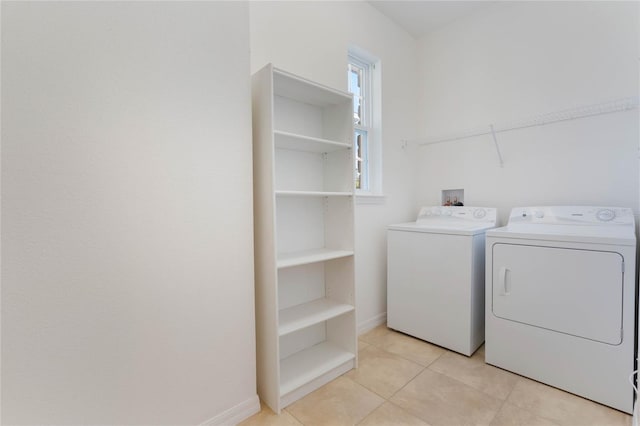 washroom with light tile patterned flooring and separate washer and dryer