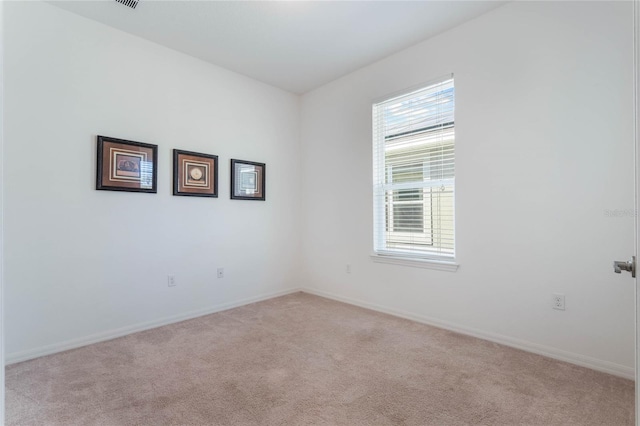 unfurnished room with light colored carpet