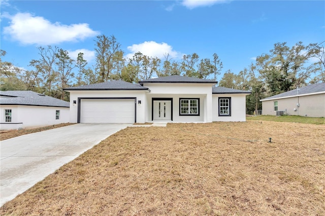 view of front facade with a garage and a front lawn