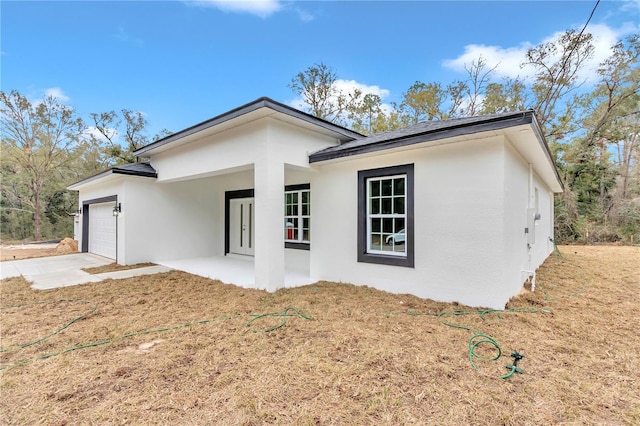 view of front of house with a front yard and a garage