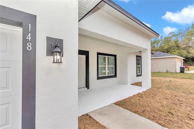 property entrance with a patio area