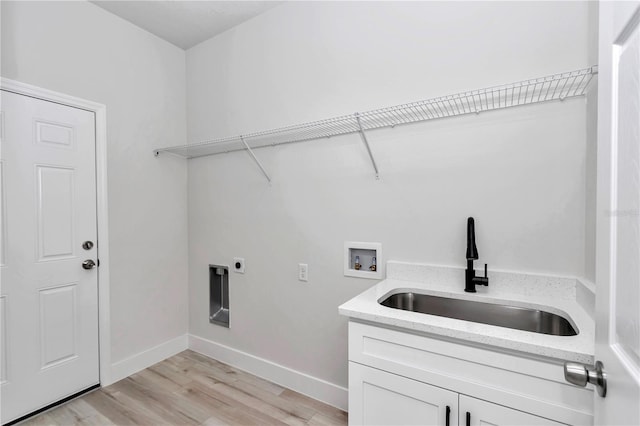 laundry room featuring electric dryer hookup, cabinets, sink, washer hookup, and light hardwood / wood-style floors