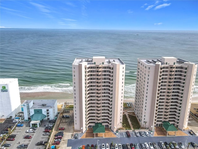 birds eye view of property featuring a water view and a beach view