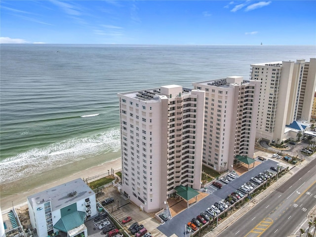 birds eye view of property with a water view and a view of the beach