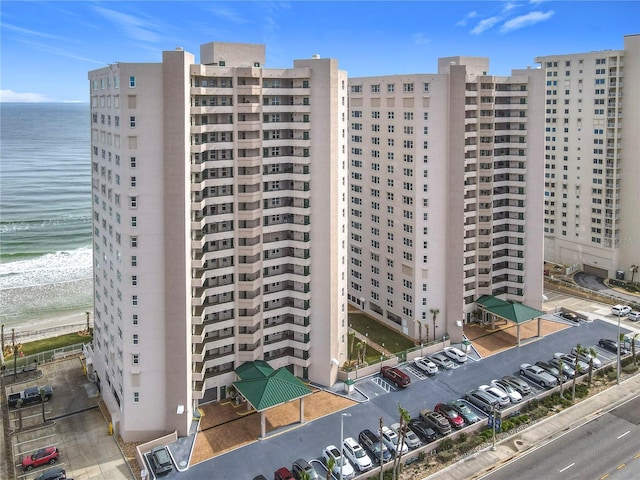 view of building exterior featuring a view of the beach and a water view