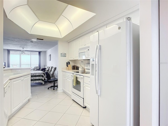 kitchen with ceiling fan, sink, light tile patterned floors, white appliances, and white cabinets