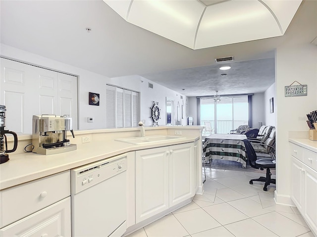 kitchen with ceiling fan, light tile patterned flooring, white dishwasher, white cabinets, and sink