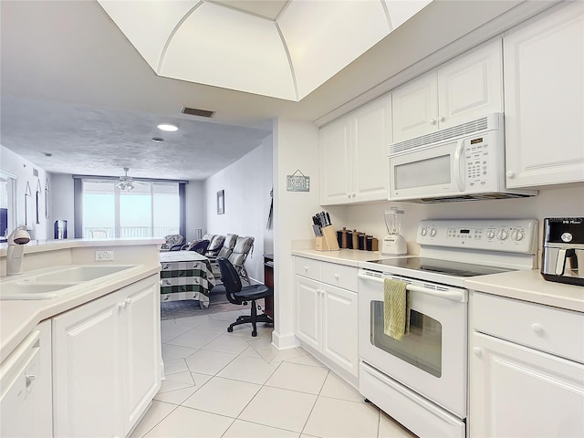 kitchen featuring ceiling fan, sink, light tile patterned floors, white appliances, and white cabinets